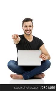 Latin man sitting on the floor and working with a laptop with both arms up