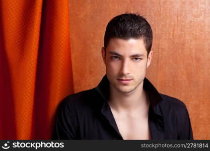 Latin spanish man portrait open black shirt with curtain and orange vintage background