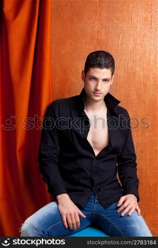 Latin spanish man portrait open black shirt with curtain and orange vintage background
