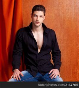 Latin spanish man portrait open black shirt with curtain and orange vintage background