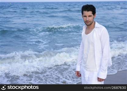 Latin young man white shirt walking on blue beach outdoor