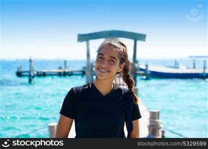Latin young woman smiling in a Caribbean pier beach of Mayan riviera