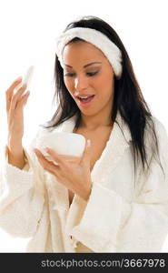 latina girl in white bathrobe looking at dusting powder holder with surprise