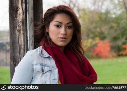 Latino woman outdoors with red scarf