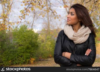 Latino woman with arms crossed looking at copy space