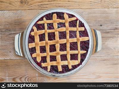 Lattice cake with berries on a rustic wooden board.. Lattice cake with berries on a rustic wooden board