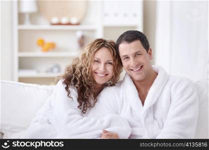 Laughing attractive couple in dressing gowns
