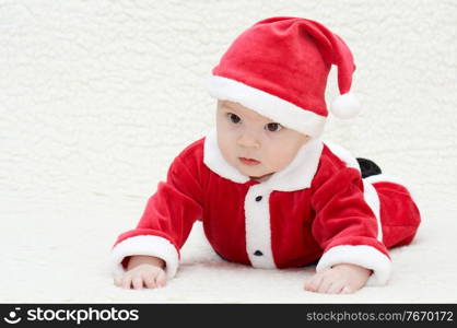 laughing baby in santa’s suit