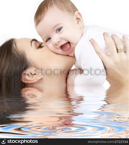 laughing baby playing with mother in water