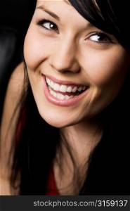 Laughing black haired woman in red top