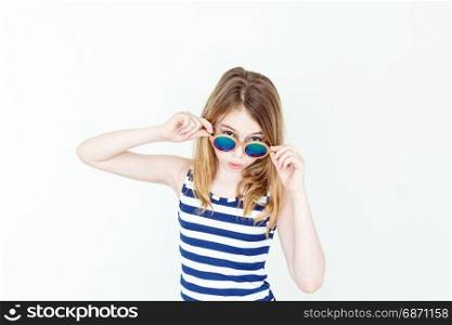 Laughing blond girl in green sunglasses on white