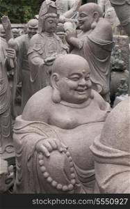Laughing Buddha statues in Panjiayuan antique market, Beijing, China