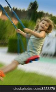Laughing Caucasian Girl On A Swing