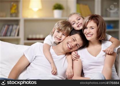 Laughing families with children at home in the evening