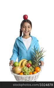 Laughing girl carrying a fruit basket