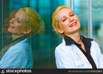 Laughing modern business woman standing at office building &#xA;