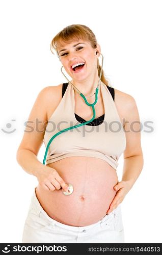 Laughing pregnant woman holding stethoscope on her belly isolated on white&#xA;