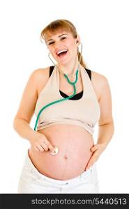 Laughing pregnant woman holding stethoscope on her belly isolated on white&#xA;