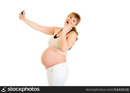 Laughing pregnant woman photographing herself isolated on white&#xA;