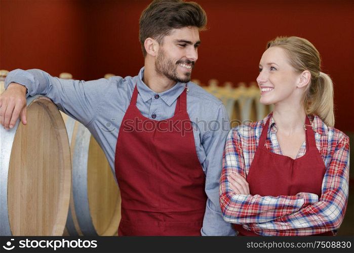 laughing professional team of winery in wine cellar