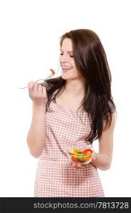 laughing woman eating salad. happy young woman with red apron eating salad on white background