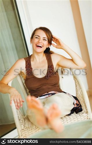 Laughing woman relaxing on terrace