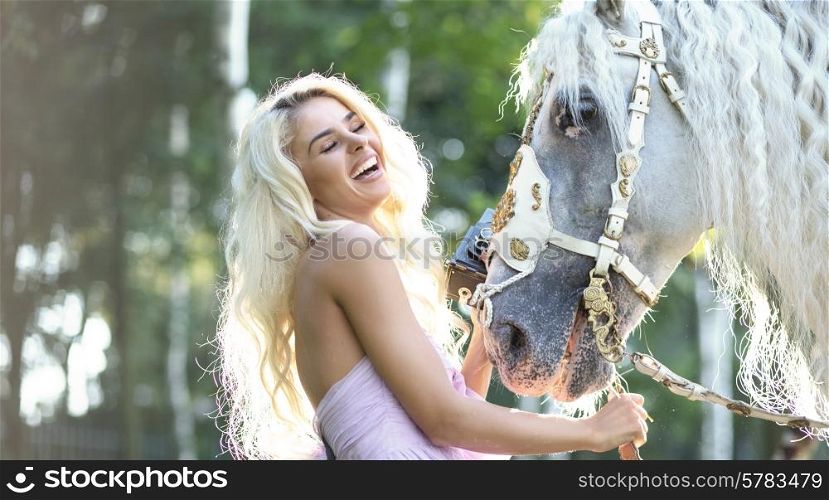 Laughing woman taking pictures of the majestic horse