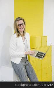 laughing woman with laptop office