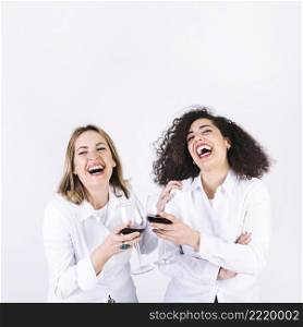 laughing women clinking glasses