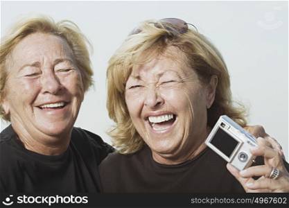 Laughing women with digital camera