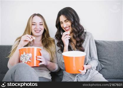 laughing women with popcorn