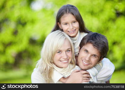 Laughing young parents with a daughter outdoors