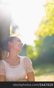 Laughing young woman relaxing in forest