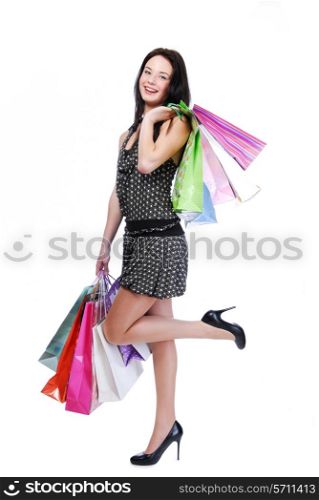 Laughing young woman standing isolated on white with color bags