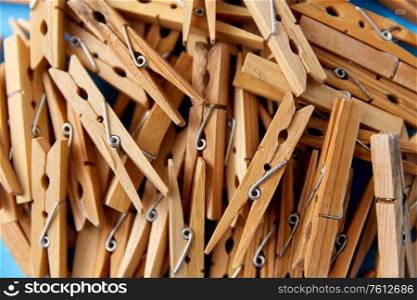 laundry and eco living concept - close up of wooden clothespins on blue background. close up of wooden clothespins on blue background