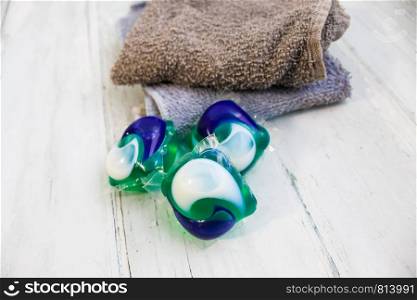 Laundry Day - laundry detergent pods on a laundry folding table with washcloths.