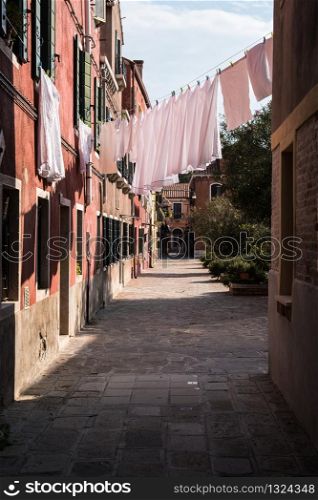 laundry drying on a rope near the open window on the streets of Venice, Italy. laundry drying on a rope near the open window on the streets of Venice