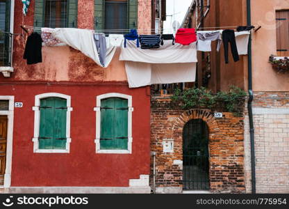 laundry drying on a rope near the open window on the streets of Venice, Italy. laundry drying on a rope near the open window on the streets of Venice