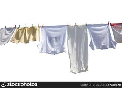 Laundry drying on the rope outside on a sunny day, isolated on white