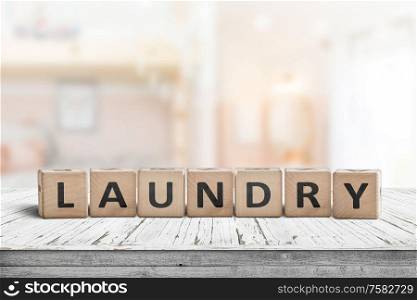 Laundry sign on a white table in a bright living room with sunlight coming in by the window