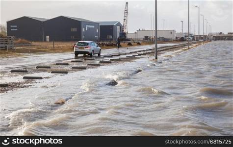 Lauwersoog, Netherlands - 6 December 2013: Extreme high tide at the dikes of the dutch coastal works, danger of flooding of a small harbour.
