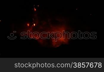 Lava exploding out from a lava tube in Hawaii at night