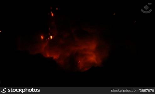 Lava exploding out from a lava tube in Hawaii at night