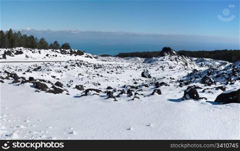 Lava field covered with snow in winter on Etna volcano, Sicily