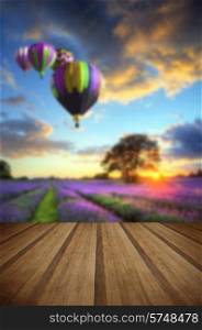 Lavender fields in English countryside landscape with hot air balloons flying high with wooden planks floor