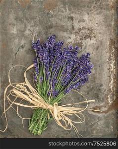 Lavender flowers with shabby chic style decorations. Fresh blossoms over rustic metal background