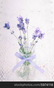 Lavender in bottle, decor provance style on a crochet tablecloth, shabby chic