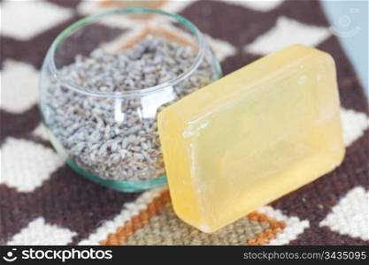 lavender in bowl and soap on ethnic mat