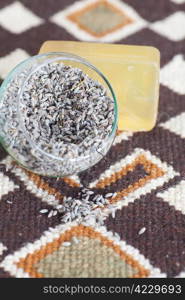 lavender in bowl and soap on ethnic mat
