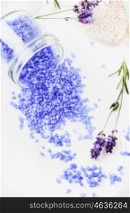 Lavender sea salt in glass with fresh flowers on light background, top view